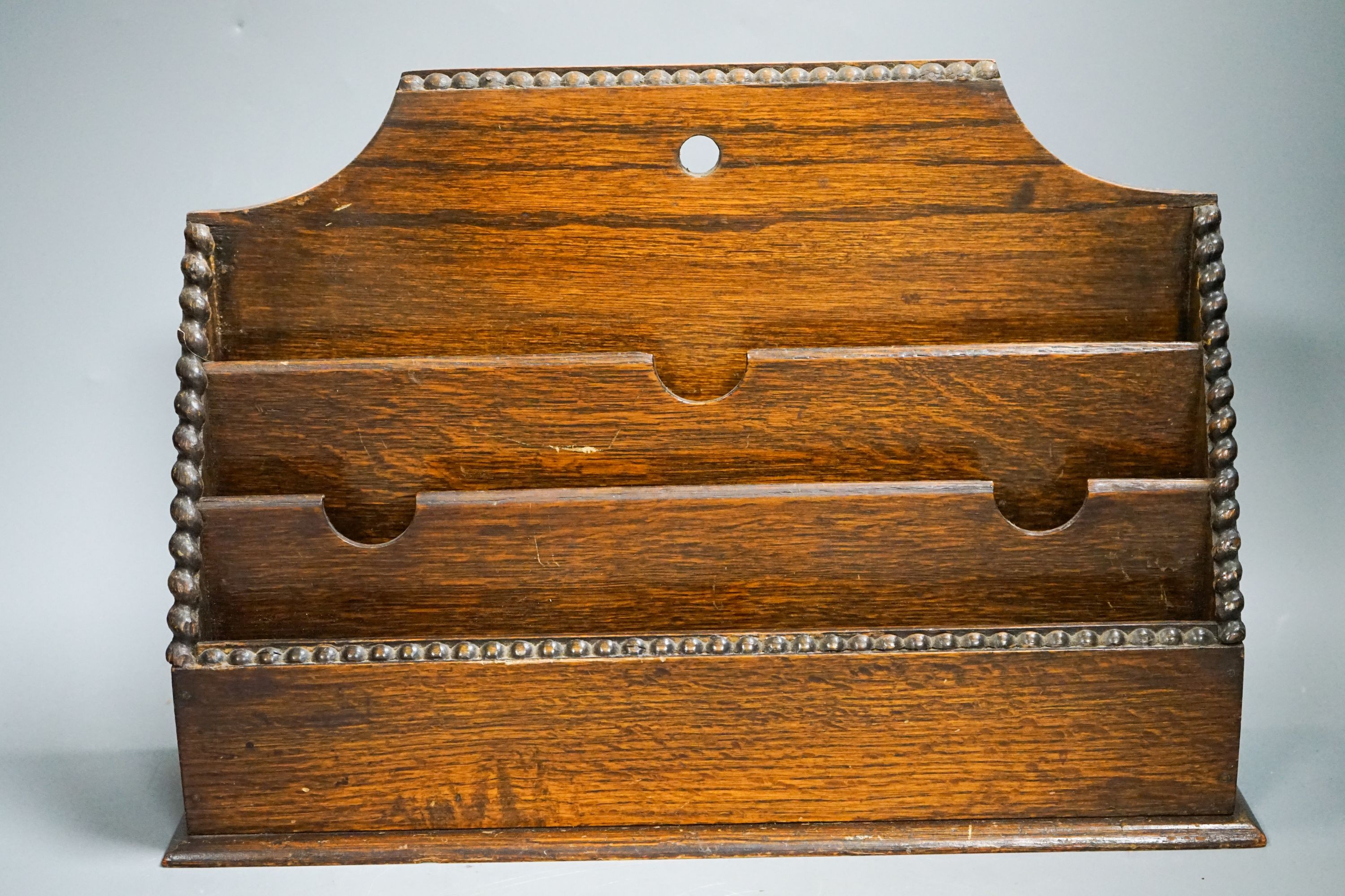 A bronzed metal greyhound, an Edwardian oak letter rack and a sarcophagus tea caddy.